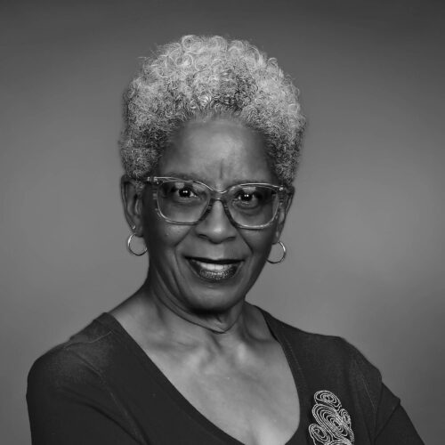 portrait of a woman smiling with glasses