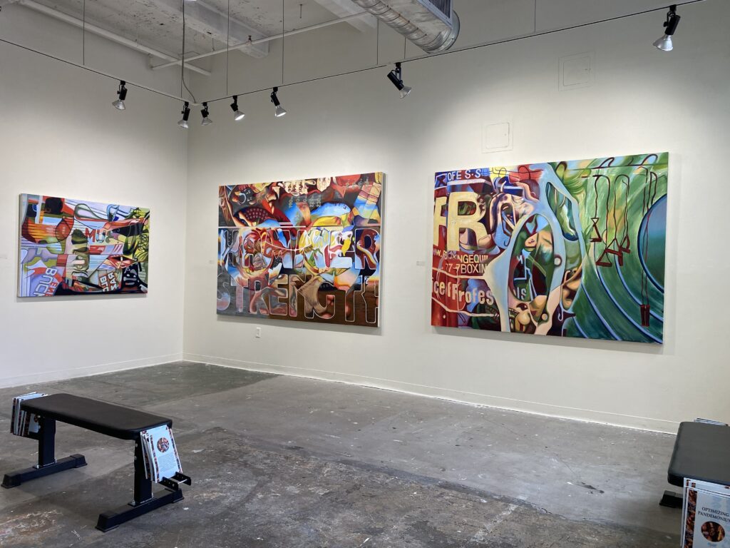 three large paintings on a gallery wall by Claire Sinsley