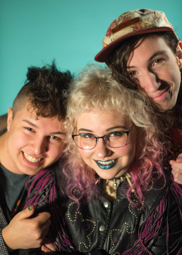 three students smiling