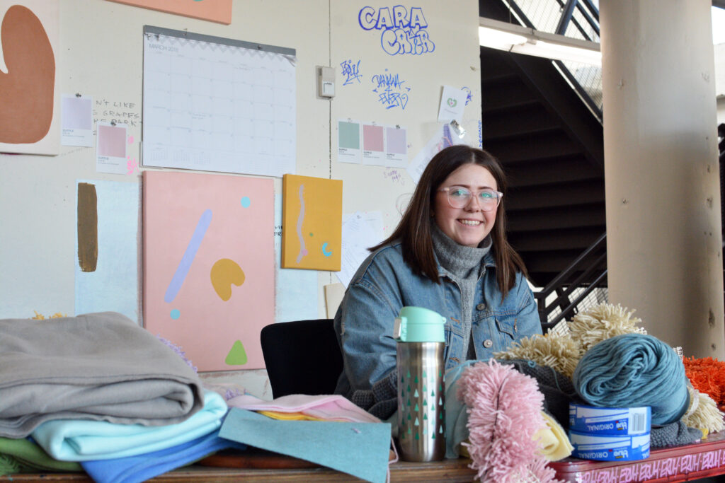 student in studio with yarn