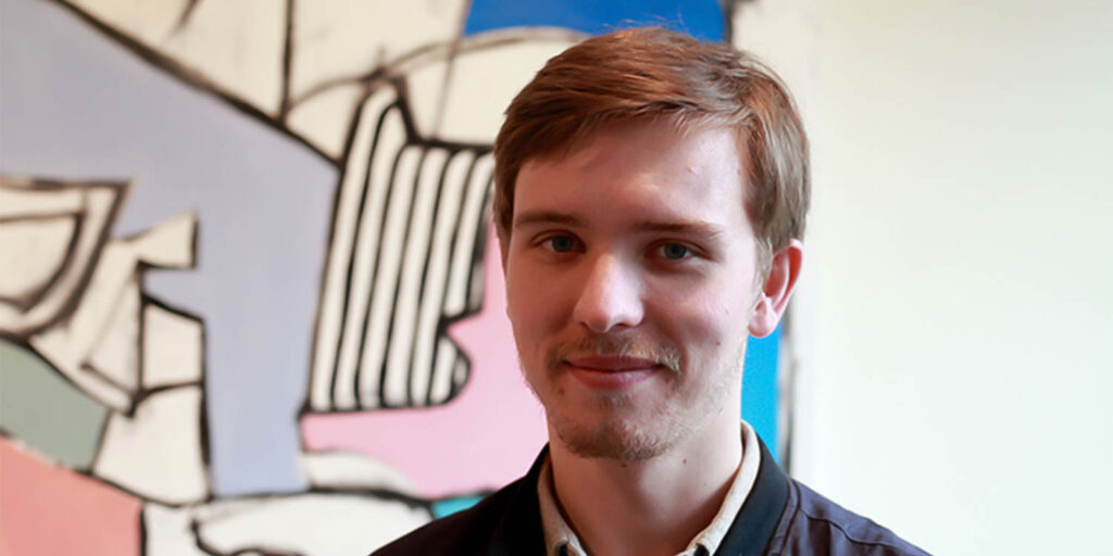 student portrait with art behind him