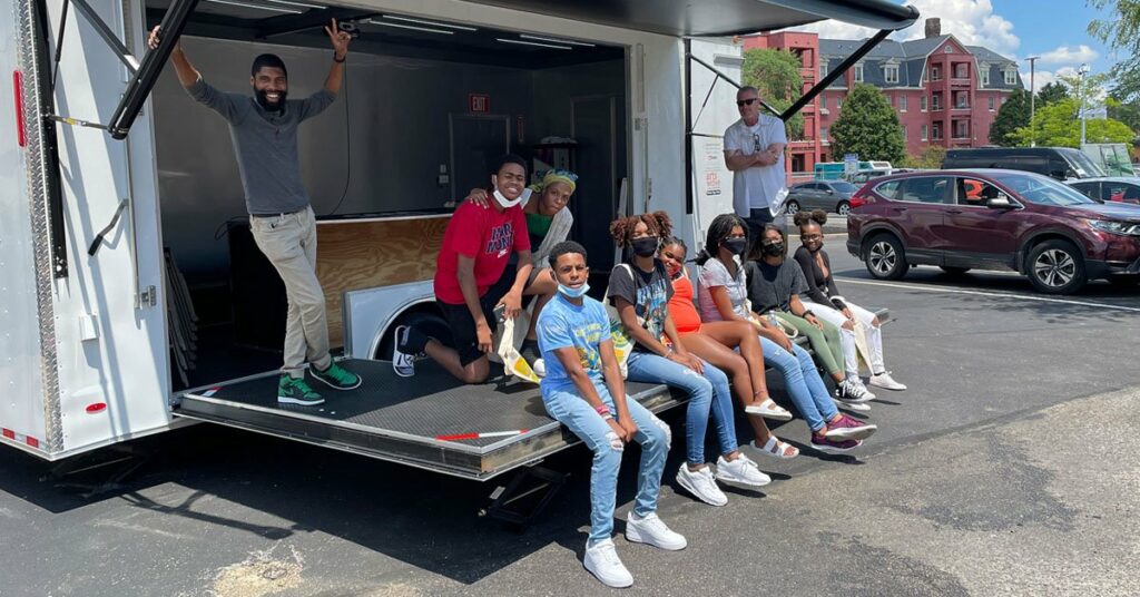 kids smiling outside of trailer