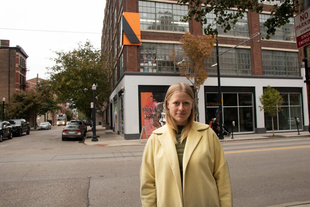 portrait of woman standing in front of building