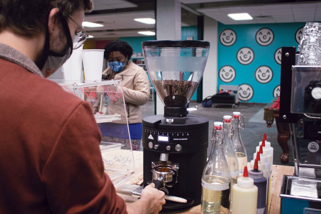 behind the counter of Sunny Blu coffee shop in the commons