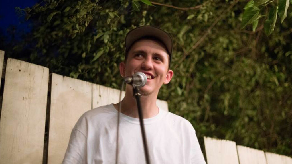 young man talking into microphone