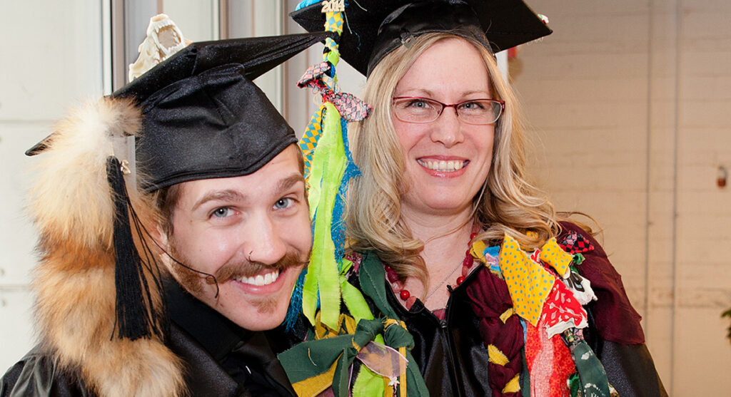 faculty members dressed up in silly graduation attire posing