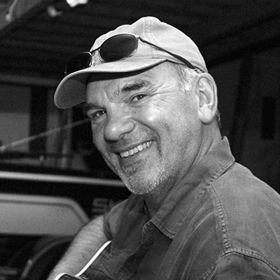 black and white headshot of man with hat