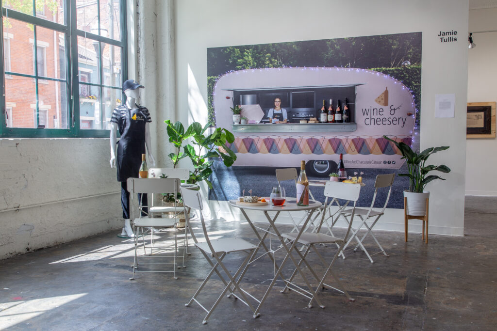 wine and cheese mockup food truck with tables in gallery