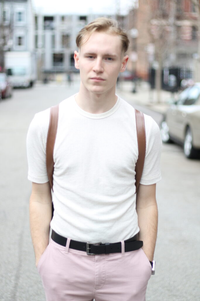portrait of man in street with white shirt and pink pants