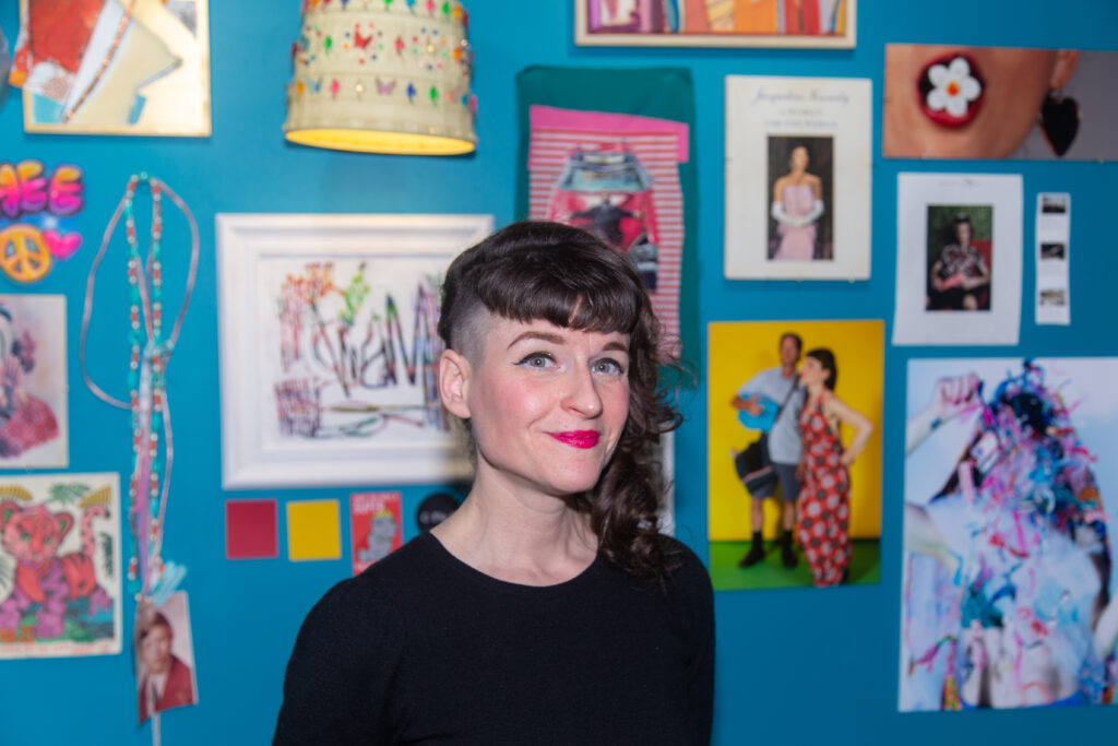 woman standing in front of art on wall