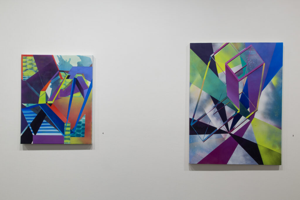 two colorful geometric paintings on wall