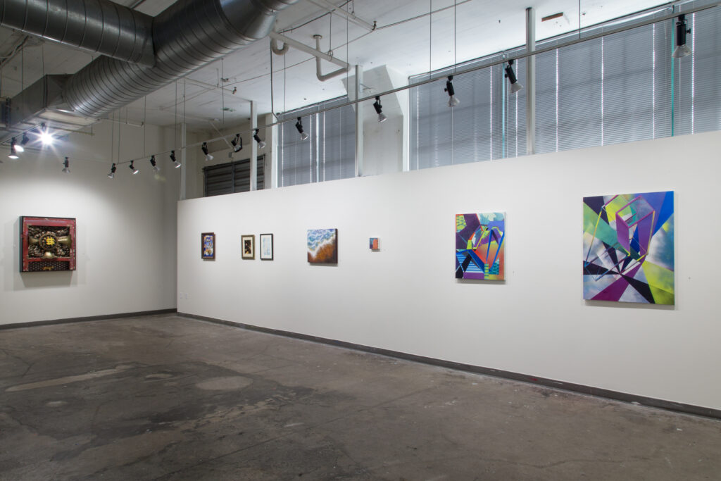 geometrical paintings hanging in gallery