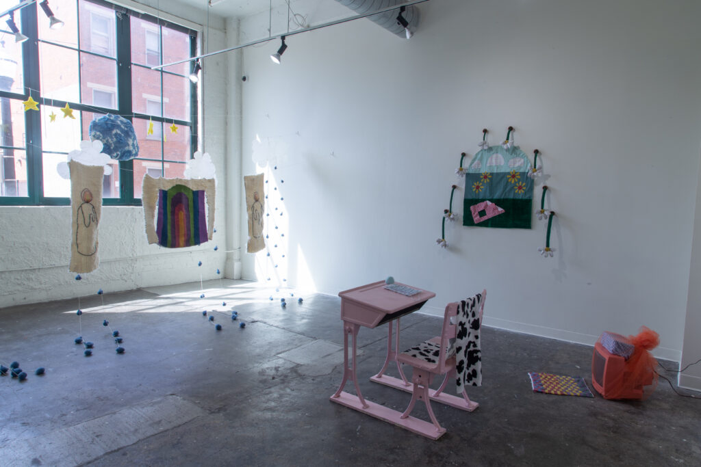 gallery installation of hanging textile sculptures