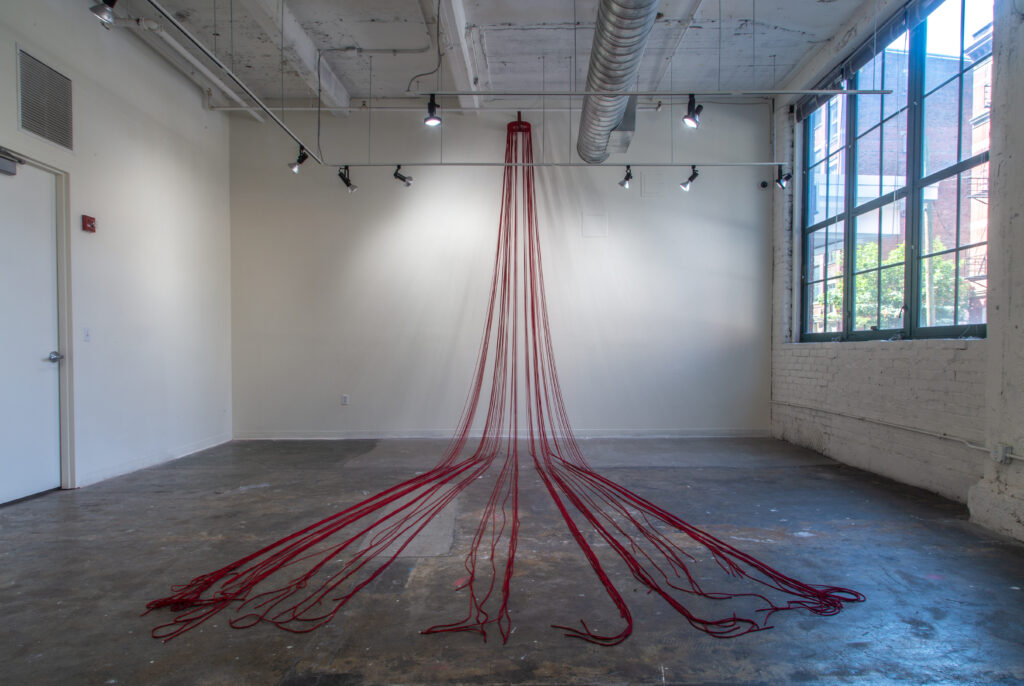 red rope installation in art gallery