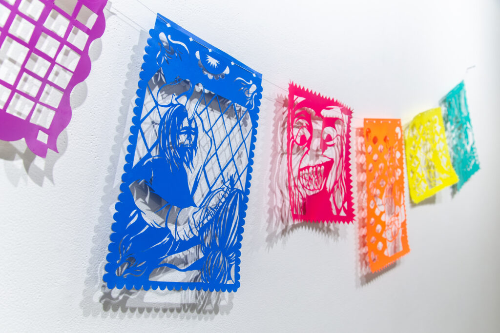 colorful cut paper (papel picado) on string