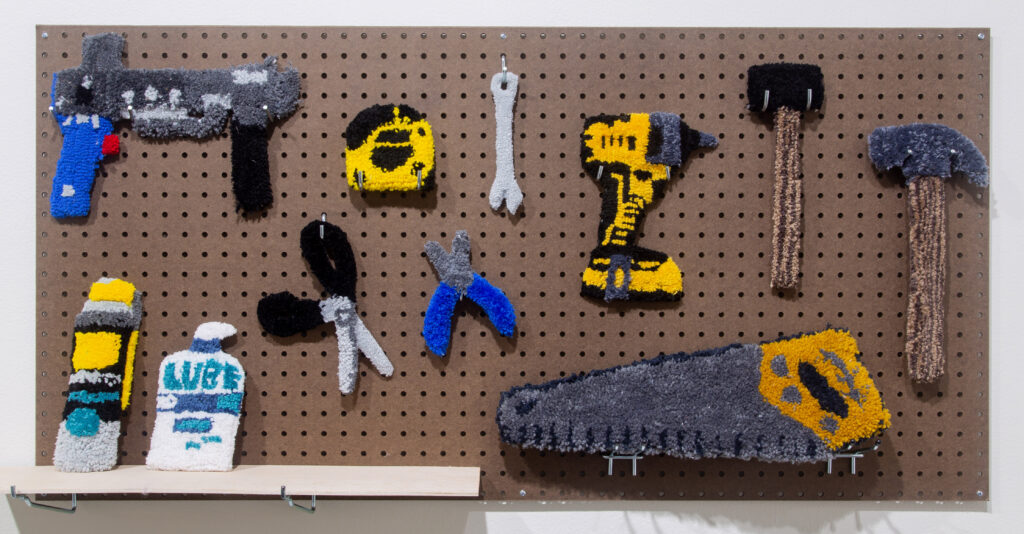 soft sculptures of tools on pegboard