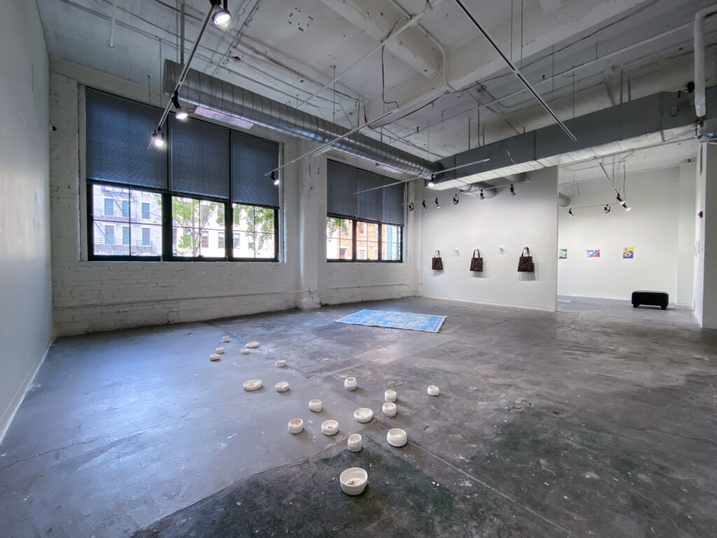 gallery interior with sculpture and textile installations