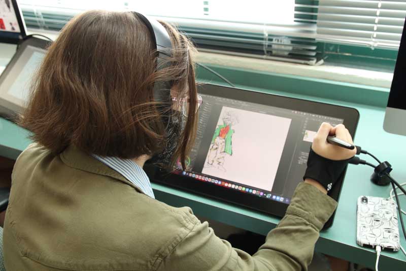 student drawing on tablet