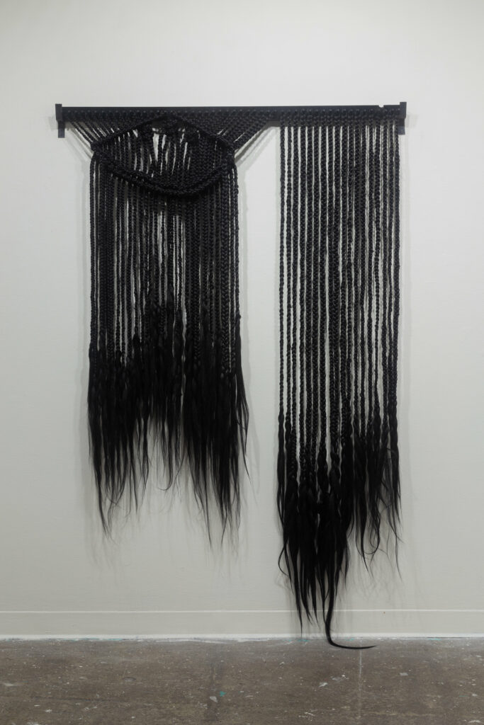 black braided hair wall sculpture