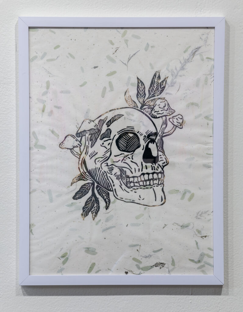 relieft print of skull and mushrooms