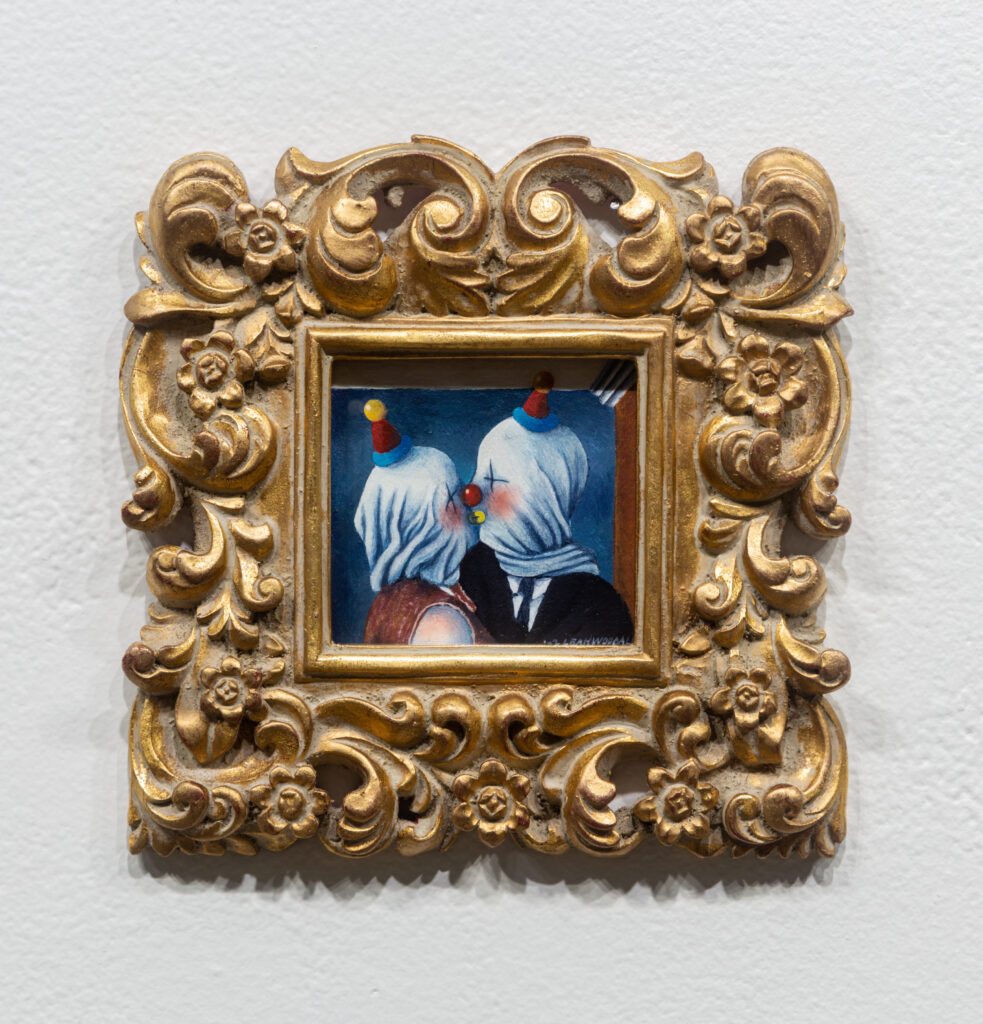 clown painting of two figures kissing in gold frame
