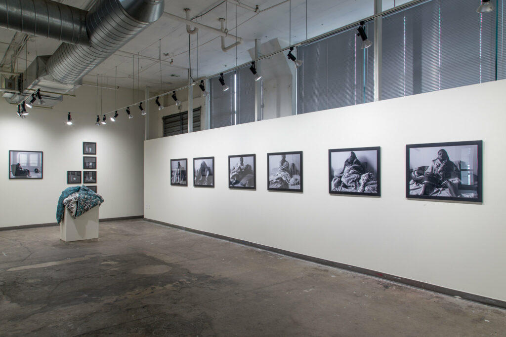 gallery installation of framed black and white photographs