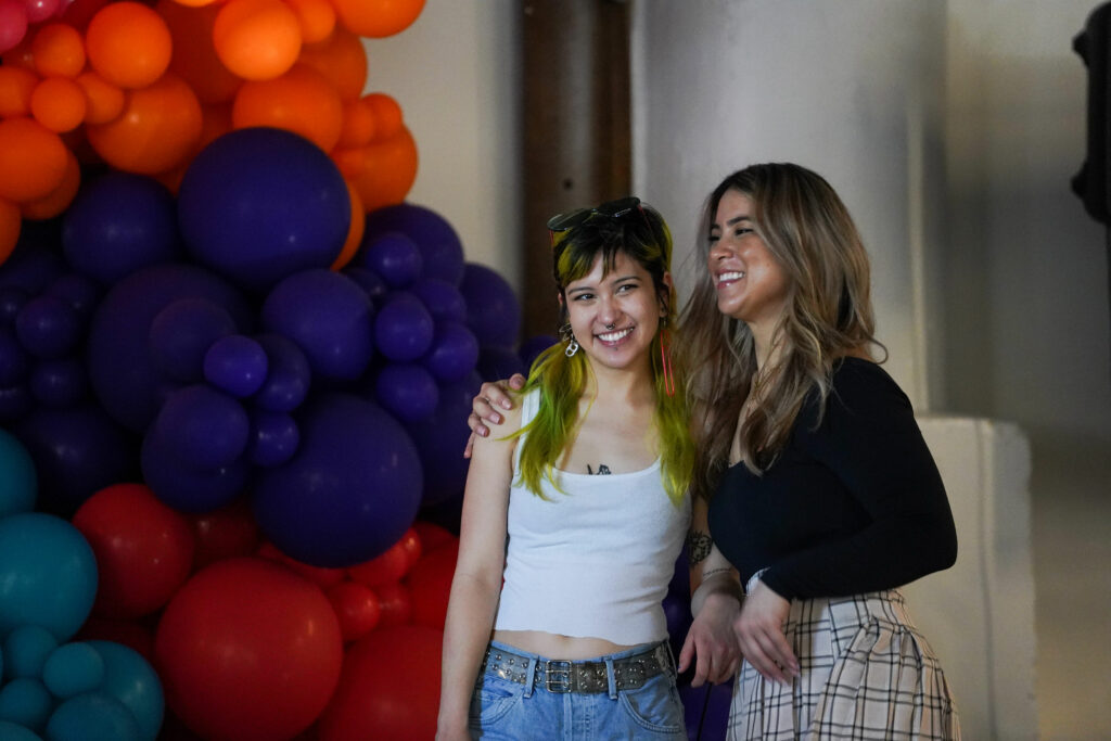two women smiling with balloons