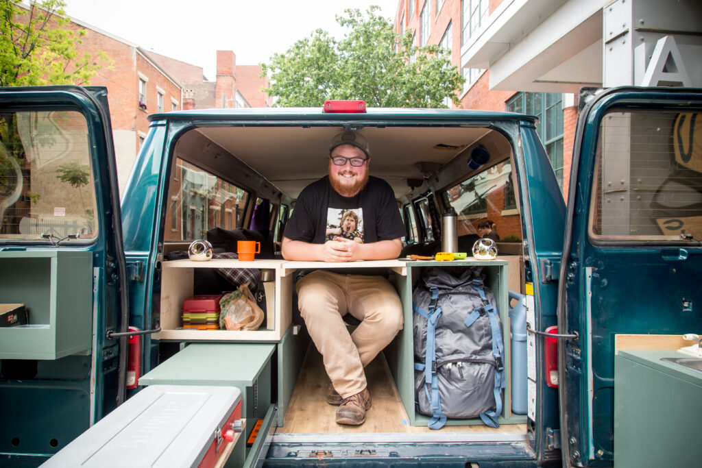 man inside of van with doors open