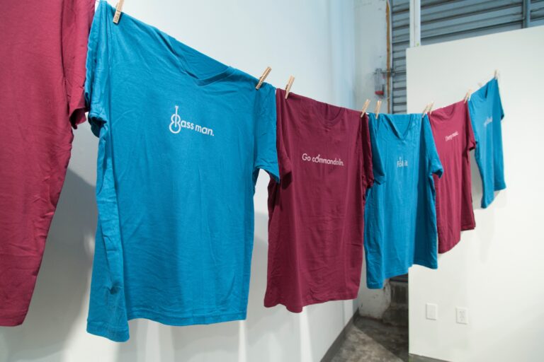 blue and maroon t shirts on line reading "folk it"