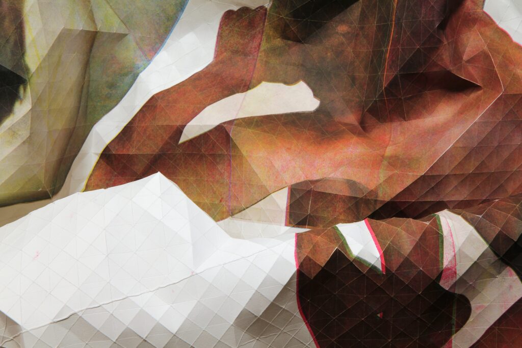 detail shot of abstracted body parts printed on paper sculpture