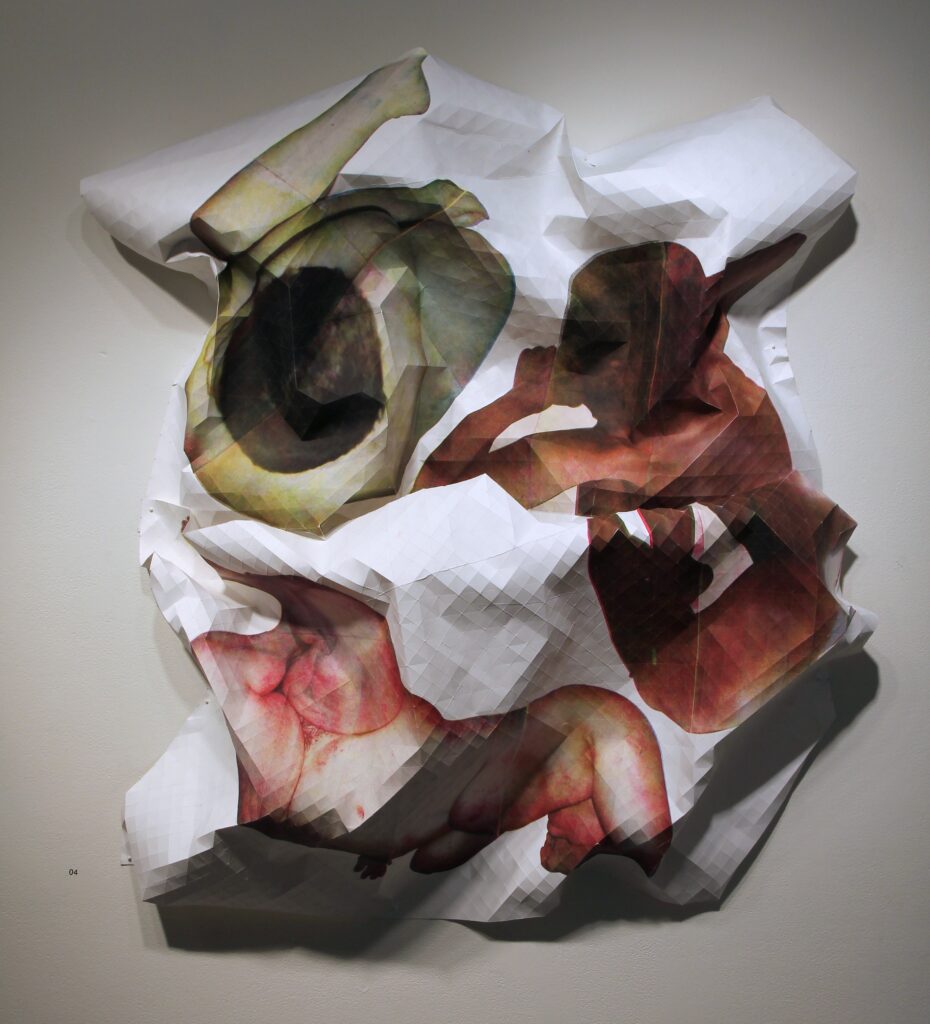 sculptural paper form printed with abstracted images of bodies hanging on wall