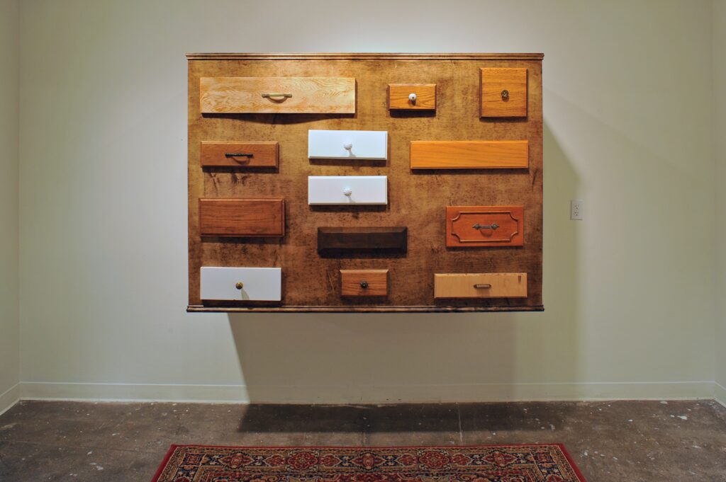 wood cabinet wall sculpture with various drawers