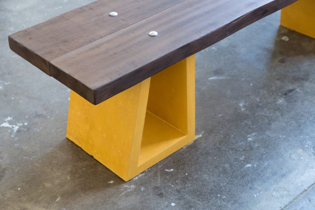 detail of bench with wood and yellow concrete base