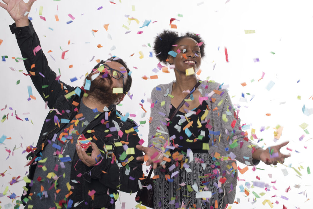 two students throwing confetti