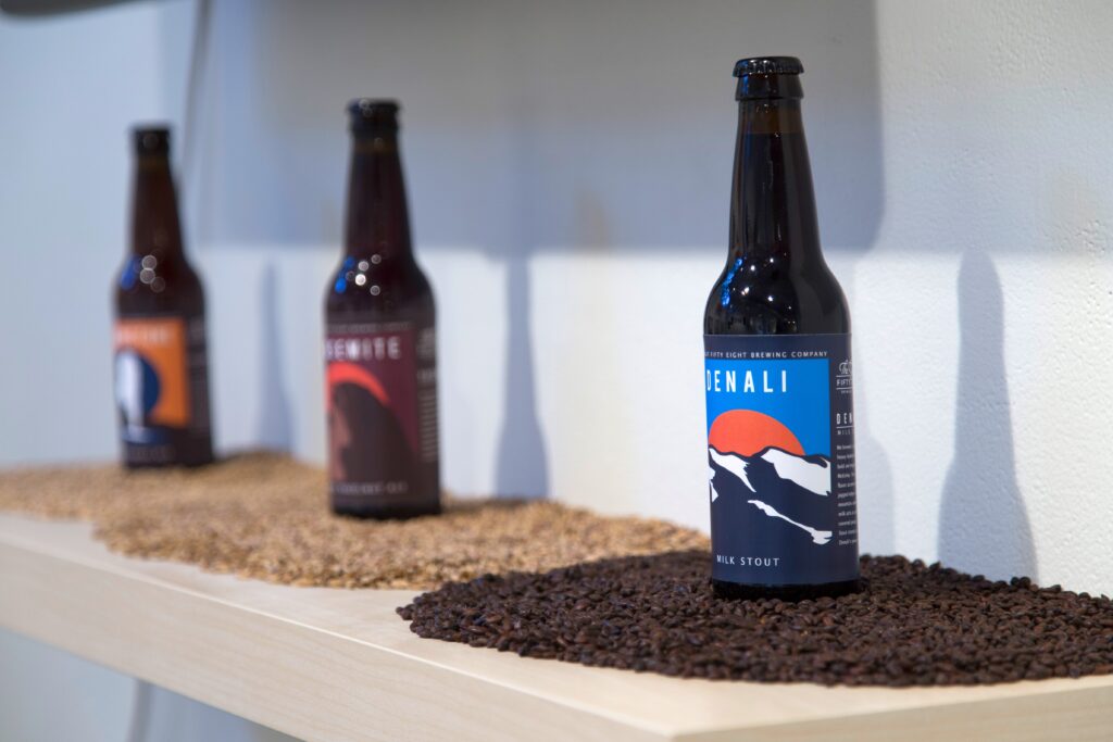 shelf with beer bottle label designs of national parks and ingredients