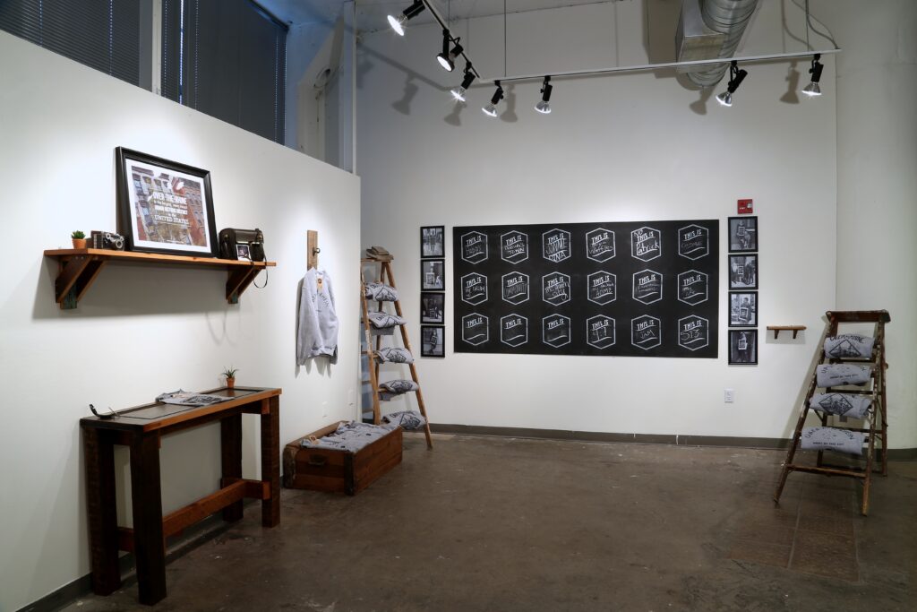 pop-up shop in gallery with posters and ladder