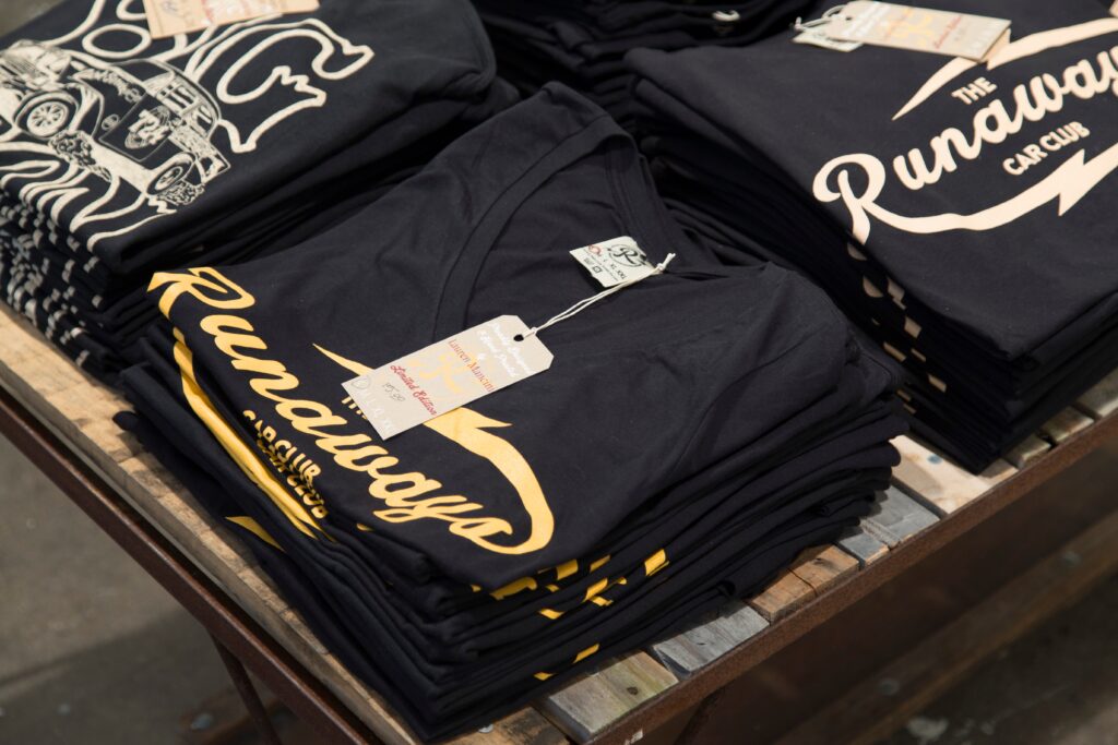 piles of folded hand printed t-shirts