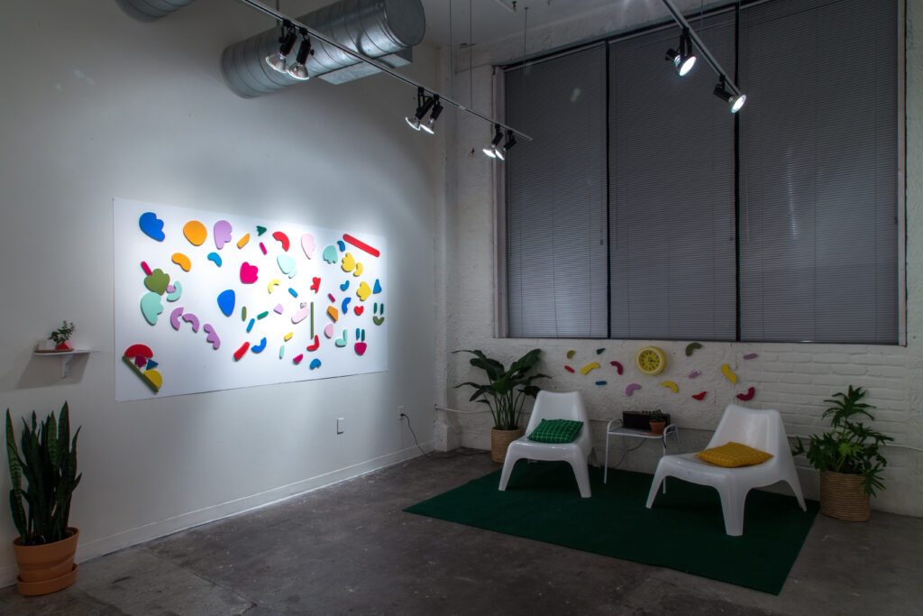 installation of painted shape wall sculptures with chairs