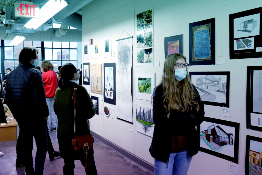 students and parents looking at art on walls