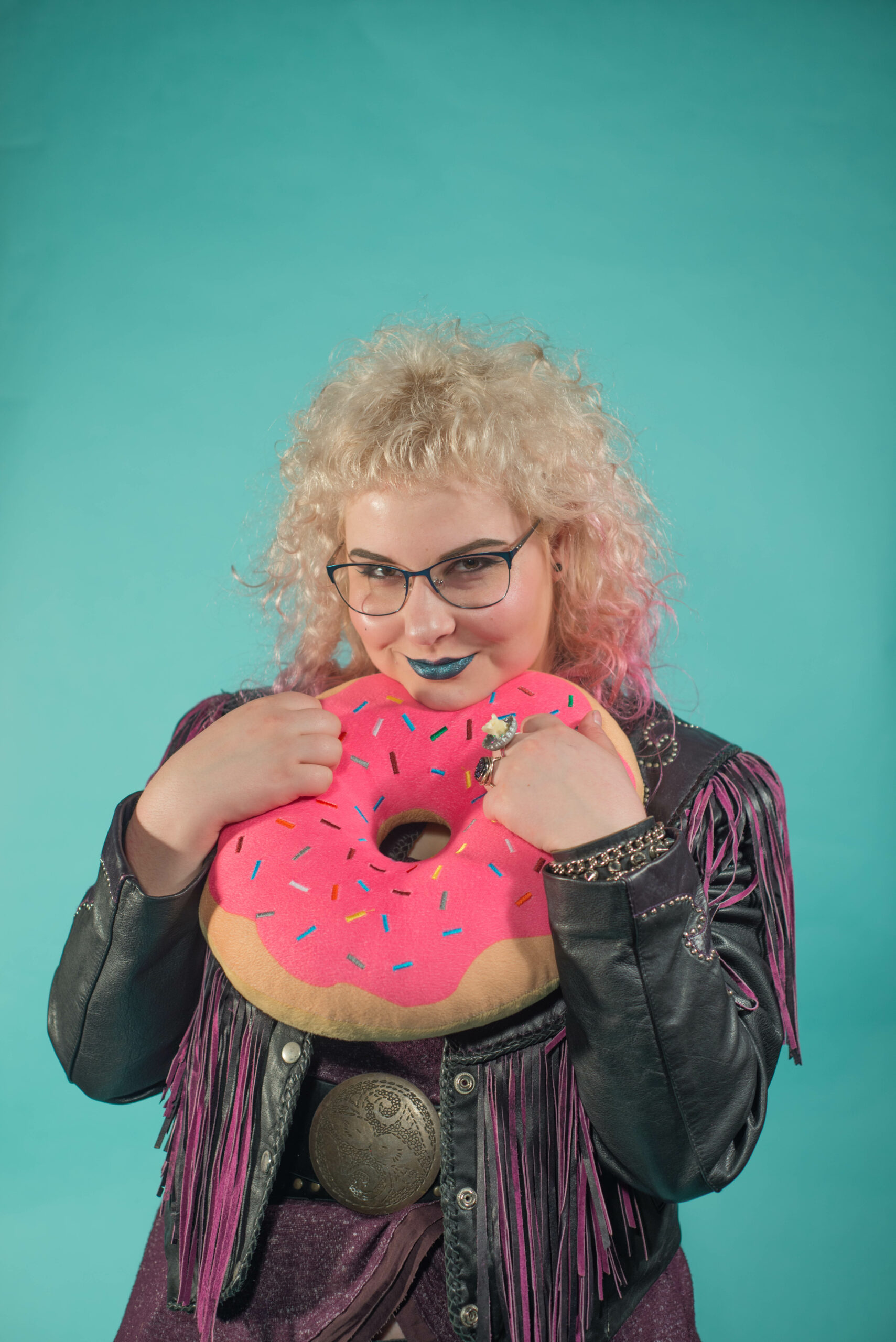 student hold soft donut sculpture smiling