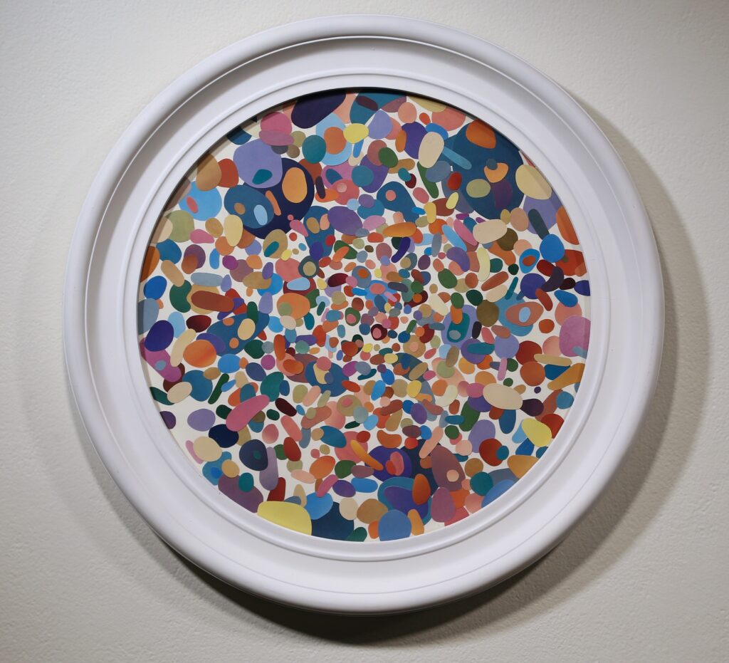circular frame filled with colorful collaged round and oblong shapes