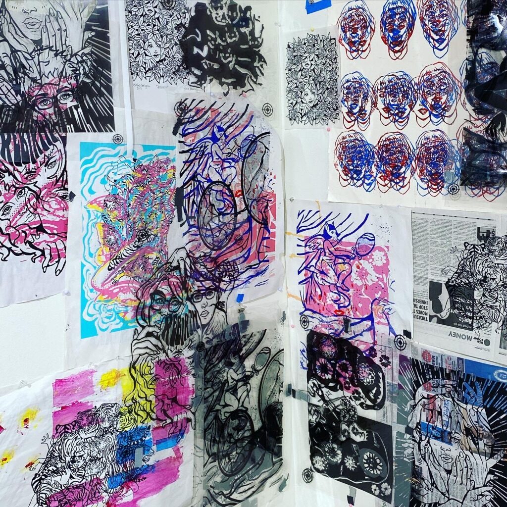 wall covered with hanging prints and stencils