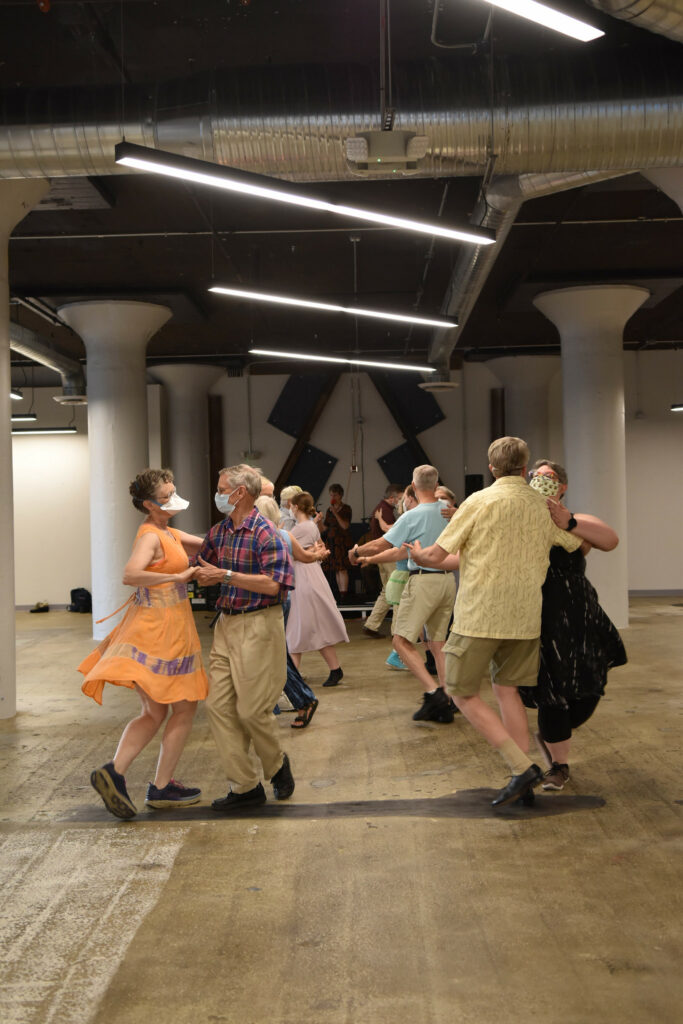 couples dancing in open space