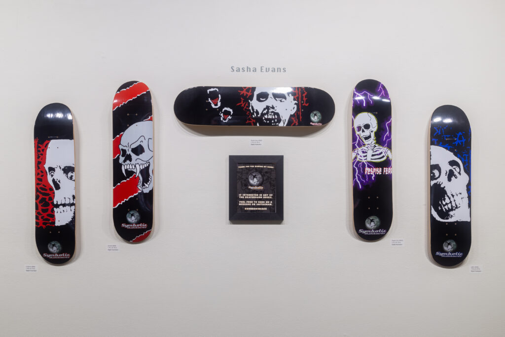 skull skateboard deck designs hanging on wall