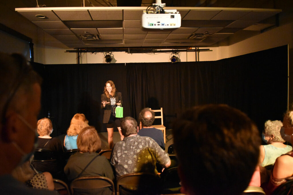 woman performing on a makeshift black stage