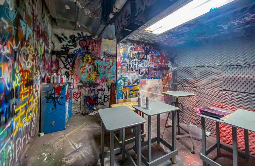 spray booth with graffiti on walls