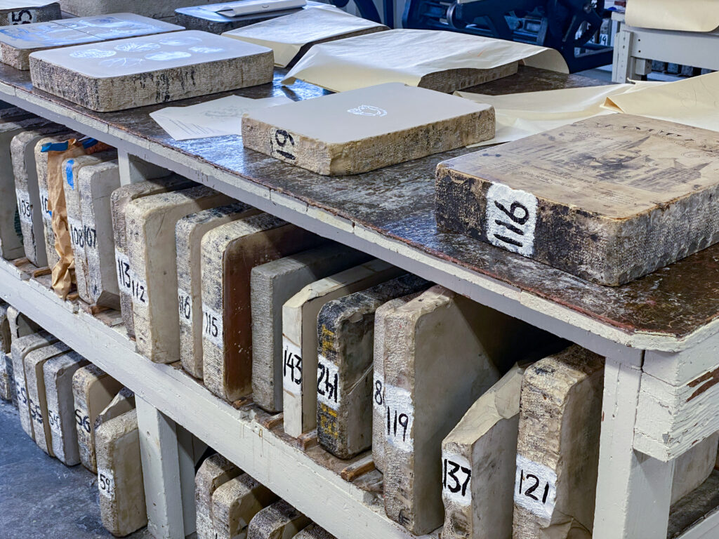 photo of lithographic stones on tabletop and shelves
