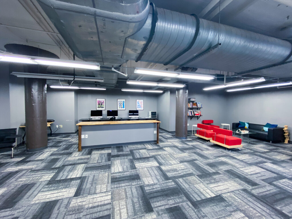 photo of classroom with computer stations and couches