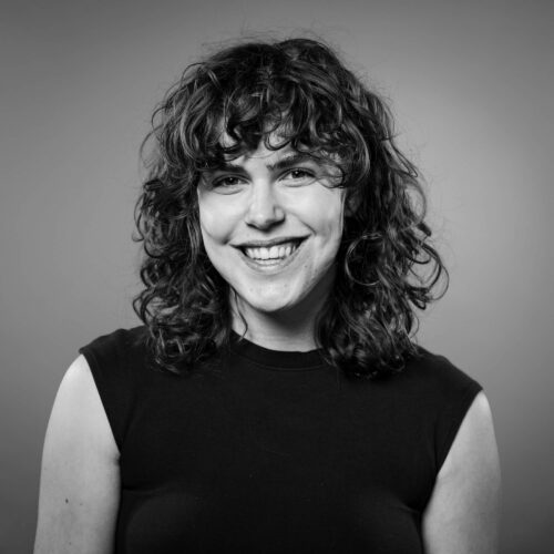 woman with curly hair smiling