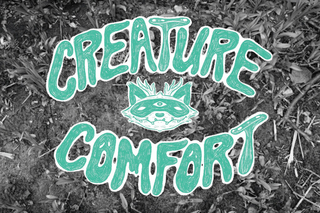 The green text "Creature Comfort" on a black and white photographic background